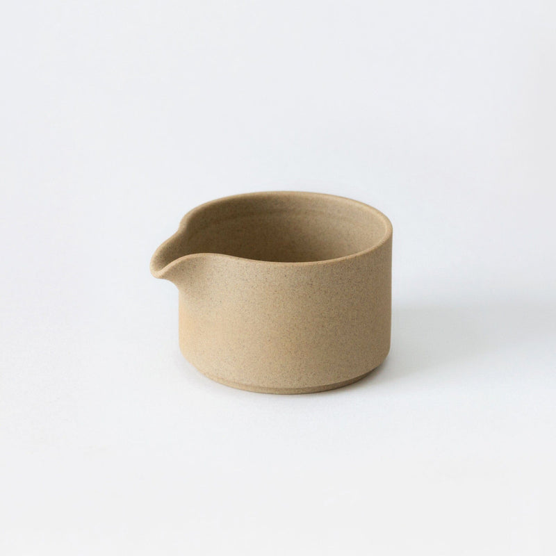 A small Saikai Toki Trading, Inc Hasami Pitcher on a white surface.