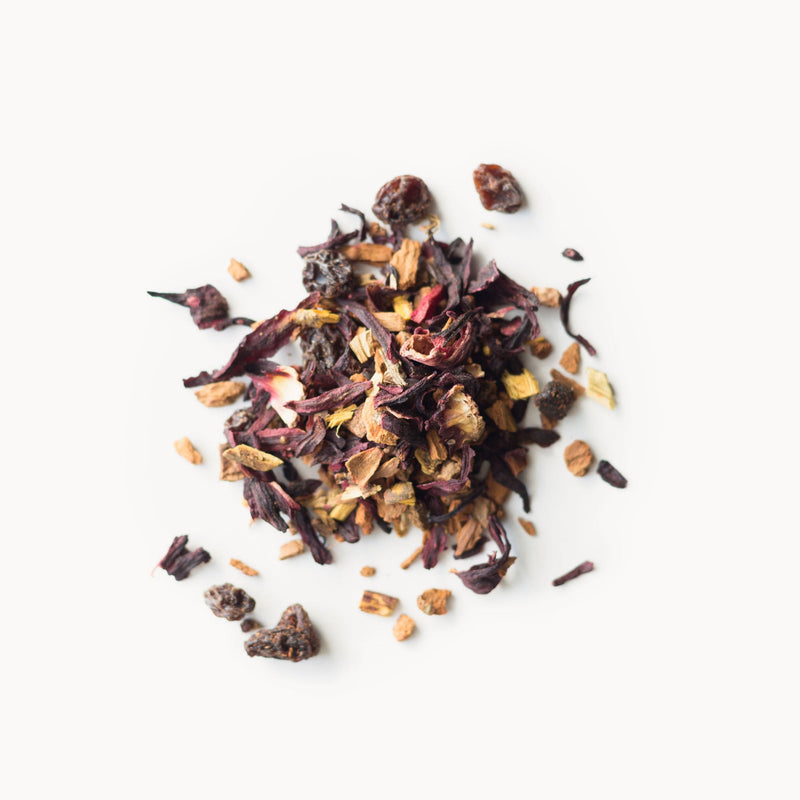 A pile of Cinnamon Plum dried fruit and berries on a white background, produced by Rishi Tea & Botanicals.