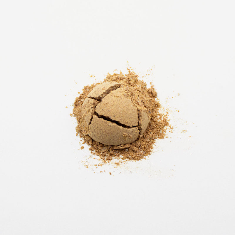 A Sweet Thai Iced Tea Powder from Rishi Tea & Botanicals on a white surface.