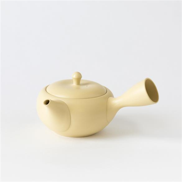 A Kikumaru Sasame Kyusu, Cream Tokoname teapot on a white background. (Brand: Rishi Tea & Botanicals)