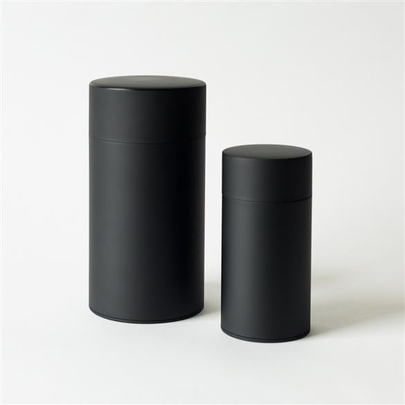 Two Kotodo Tins on a white surface.